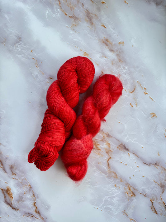 Bright red fingering weight yarn and bright red lace mohair